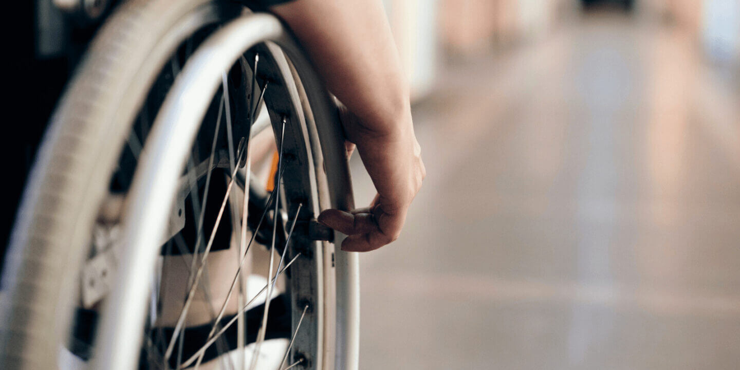 Hand on wheelchair wheel