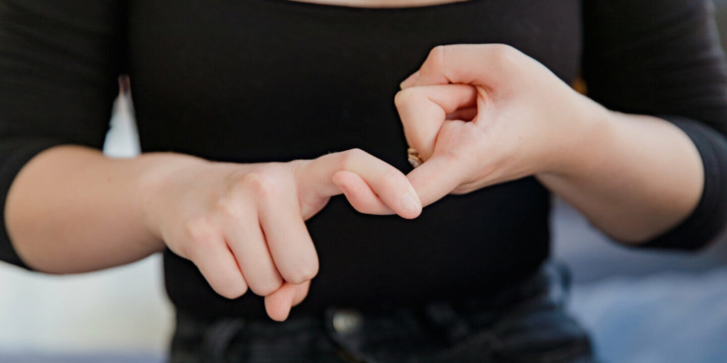 Woman crossing fingers together